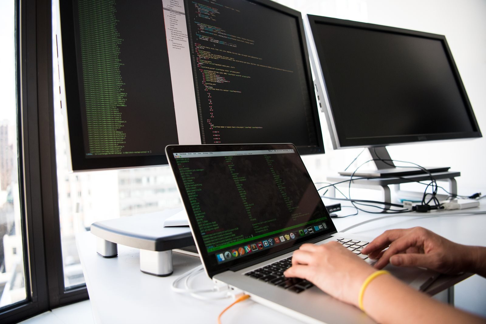 Developer workstation with code on multiple monitors