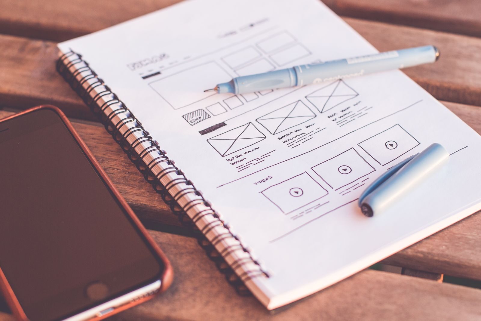 Website wireframes being sketched during the design phase